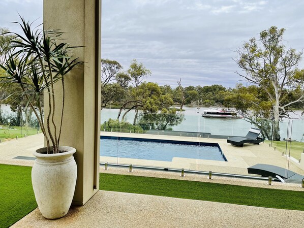 Heated swimming pool with Murray River views & glass panel fencing off alfresco