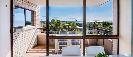 The dining room has a view over the balcony towards the surrounding beaches.