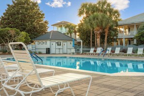 Enjoy a serene poolside atmosphere with lush greenery.