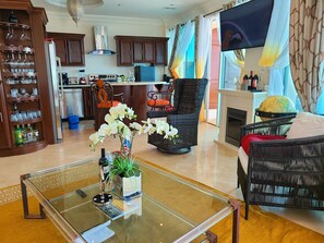 Living and kitchen island area.  All are facing the spacious glass balcony.