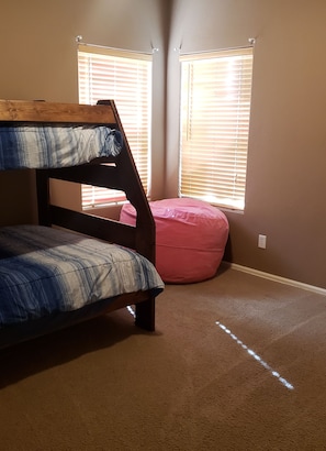 That pink bean bag unzips and another bed is inside it.