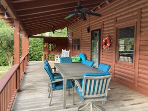 Outdoor seating with fans, overlooking the pool and the lake.