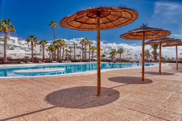 Resort entrance gate, reception, bench and gardens