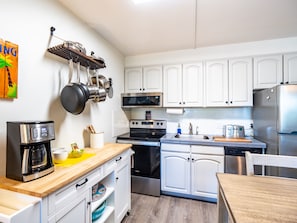 Fully equipped kitchen with quality appliances, pots and pans, and utensils. 
