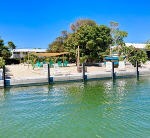 View from the water of our 50’ dock, beach area and home in the background 