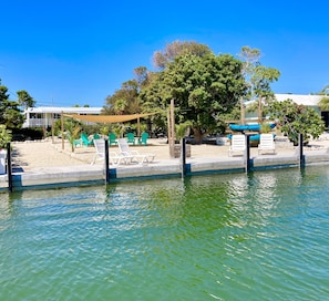 View from the water of our 50’ dock, beach area and home in the background 