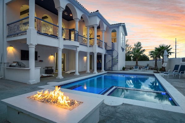 Sunset with cotton candy skies over the amazing pool and fire pit.