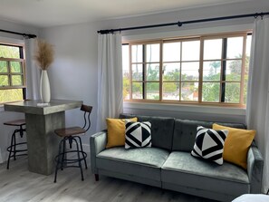 Sleeper sofa and dining area.
