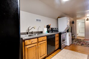 Kitchen cooking with Full Size Appliances.  Stack Washer & Dryer