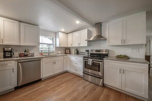 All white kitchen with stainless steel appliances