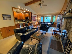 Main living area with wood burning fireplace and TV