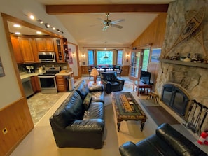 Main living area with wood burning fireplace and TV