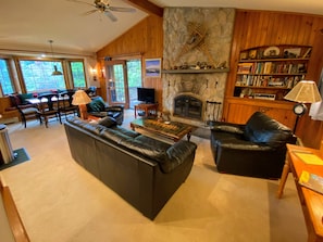 Main living area with wood burning fireplace and TV