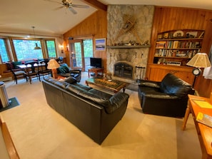 Main living area with wood burning fireplace and TV