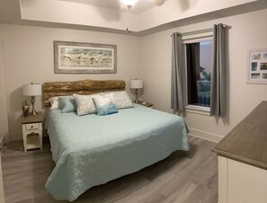 KING MASTER SUITE with private bath ad 50" wall mounted Smart Samsung TV.