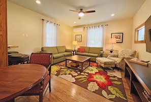 Spacious Living Room with Large Flatscreen TV Opens to Dining Room and Kitchen