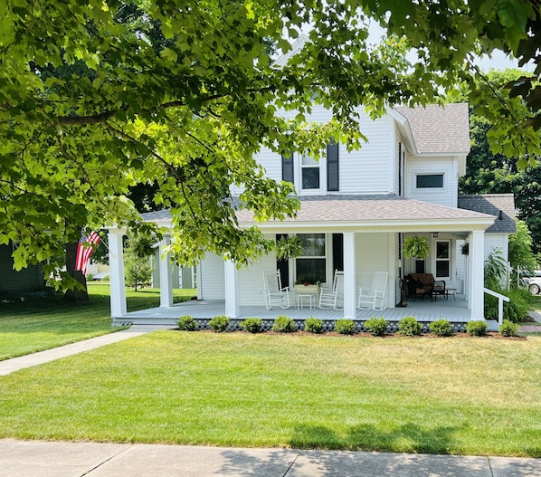 Expansive Covered Front Porch with Rocking Chairs & Seasonal Decorations
