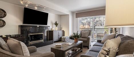 Living Room with plush furnishings and 65" Samsung Smart TV