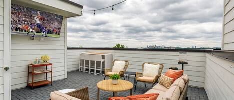 Brand new home with rooftop deck featuring large flat screen SMART TV, outdoor dining and outdoor lounging areas.