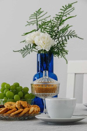 Close-up of table with vase and flowers.
