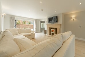 Limestone House, Burnham Market: The sitting room has a limestone fireplace