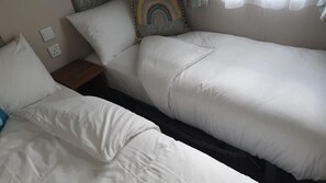 2 single beds with a mini wardrobe 