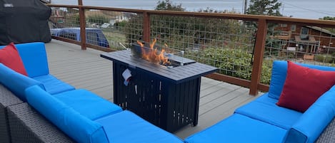 Outdoor patio furniture with fireplace  and view