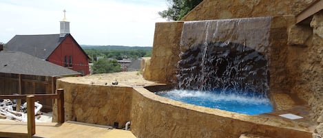 Beautiful ancient castle-like stone work waterfall cave and dipping pond. 