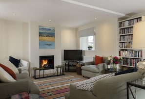 Ground floor: The sitting room with wood burning stove and comfy seating