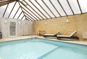 Enjoy access to the heated indoor swimming pool and steam room at Cats Abbey Cottage