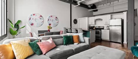 Relax in this cozy living area with stylish decor and soft, inviting pillows.