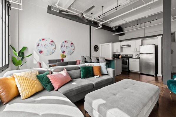 Relax in this cozy living area with stylish decor and soft, inviting pillows.
