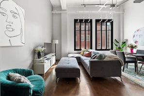 Bright and airy living space with large windows letting in natural light and city views.