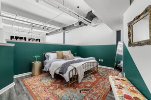Enjoy a spacious and beautifully designed bedroom with a cozy bed and vibrant accents.