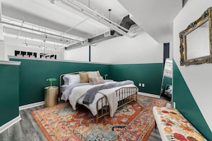 Enjoy a spacious and beautifully designed bedroom with a cozy bed and vibrant accents.