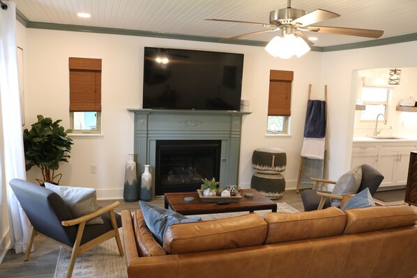 The cozy living room is relaxing and inviting.  There is a 60" Roku TV.