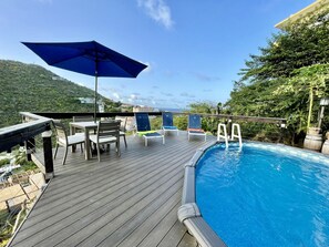 Pool with deck chairs, table and Umbrella