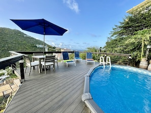 Pool with deck chairs, table and Umbrella