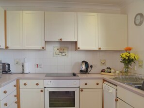 Contemporary appliances combine well with the cottage-style kitchen | Oak Tree Cottage - Newbarn Farm, Collaton St Mary, near Paignton