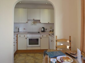The kitchen area is just a few short steps from the dining area | Oak Tree Cottage - Newbarn Farm, Collaton St Mary, near Paignton