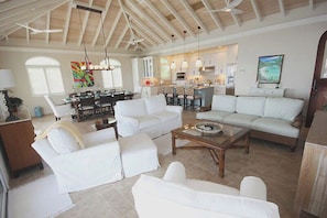 The elegant and spacious great room is also located on the upper level and includes the living area, kitchen and a dining table that seats eight