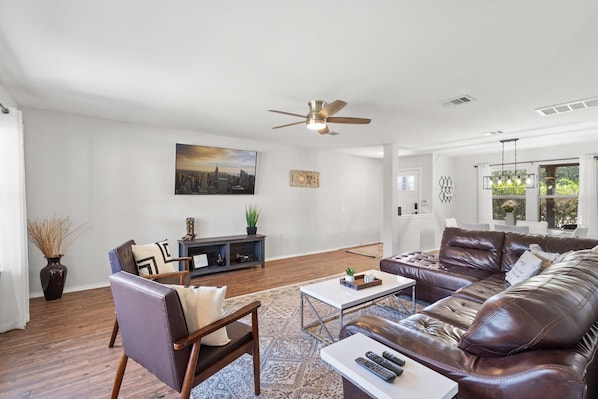 Living room with 65 inch Smart TV with cable, Netflix, HBO Max & Peacock.