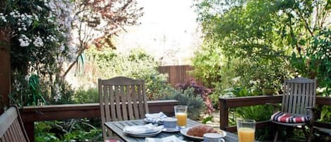 Dine al fresco on your private deck overlooking the garden.
