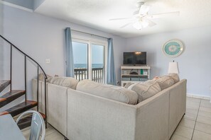 View of the living room from the dining area table, with a beach view!