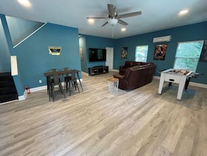 Rec Room with foosball, Ping Pong, 75 in TV, PS4, game table.