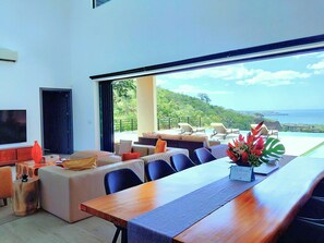 Open Concept Main Living Area with Dining table, terrace doors open up to the oceanview terrace