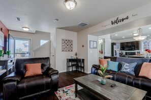 View of entire downstairs living room, 1/2 ba, kitchen, and workspace area.