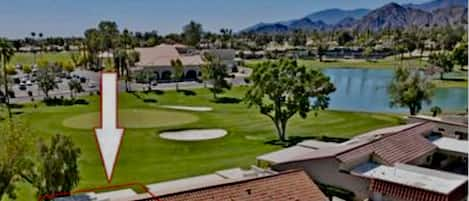 Aerial view of home with golf course, lake, clubhouse and mountains 