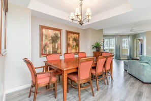 Dining Area - The dining area is open to both the living area and the kitchen and has a large table with seating for eight.