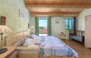 Sleeping area. One of the rooms upstairs, with the balcon terrace